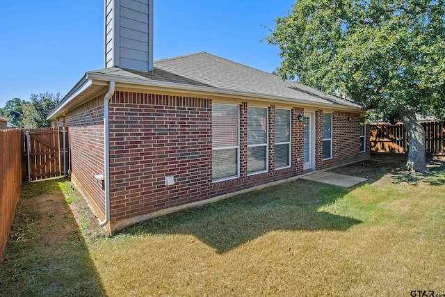 view of side of home featuring a yard