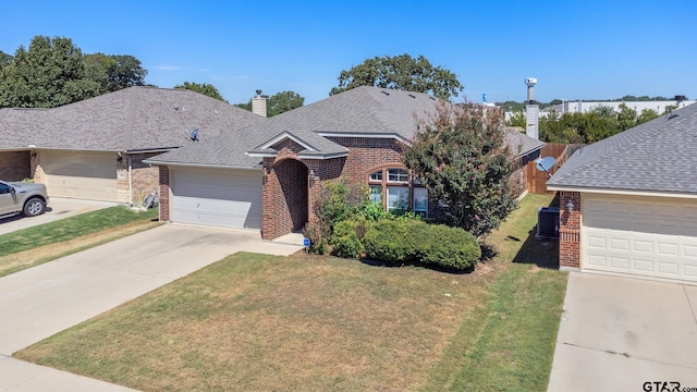 ranch-style house featuring a garage, central AC, and a front yard