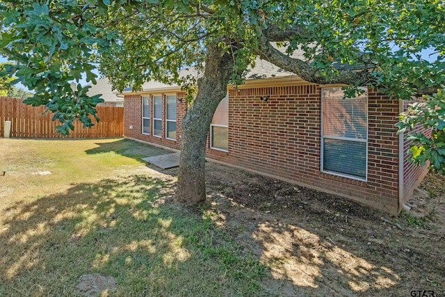 view of home's exterior with a yard