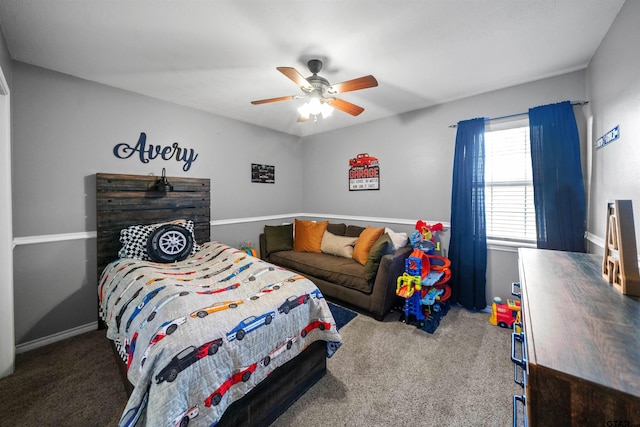 carpeted bedroom featuring baseboards and a ceiling fan