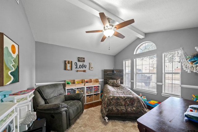 bedroom with vaulted ceiling with beams, a textured ceiling, ceiling fan, and wood finished floors