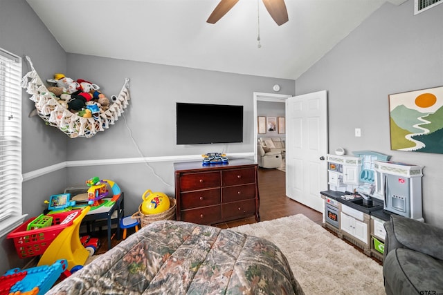 bedroom with visible vents, a ceiling fan, lofted ceiling, and wood finished floors