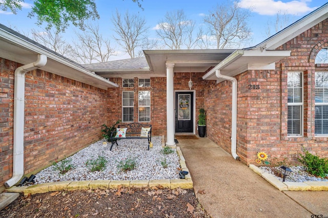 doorway to property with brick siding