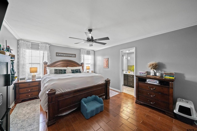 bedroom with crown molding, ceiling fan, dark wood-style flooring, and connected bathroom