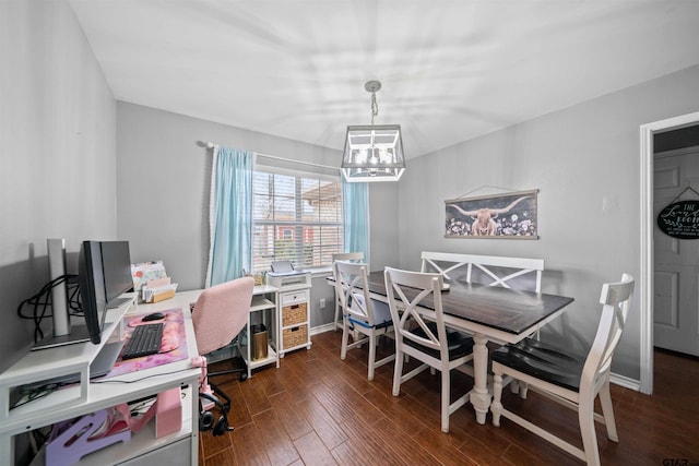 dining space featuring baseboards, dark wood-style floors, and a notable chandelier