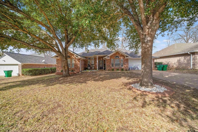 ranch-style home featuring an attached garage, a front yard, and brick siding