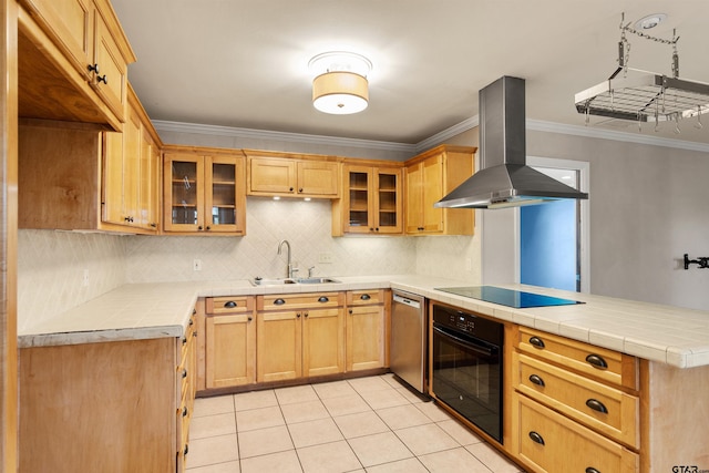 kitchen with tile countertops, black appliances, exhaust hood, and sink