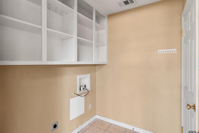 clothes washing area featuring hookup for a washing machine, light tile patterned floors, and electric dryer hookup