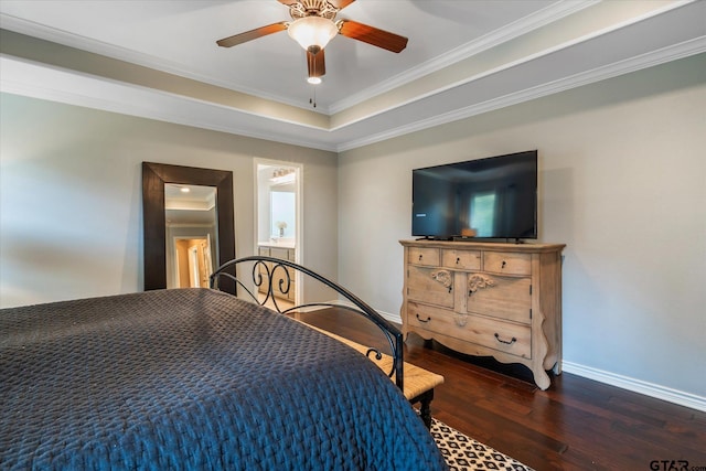 bedroom featuring baseboards, a raised ceiling, ceiling fan, ornamental molding, and dark wood-type flooring