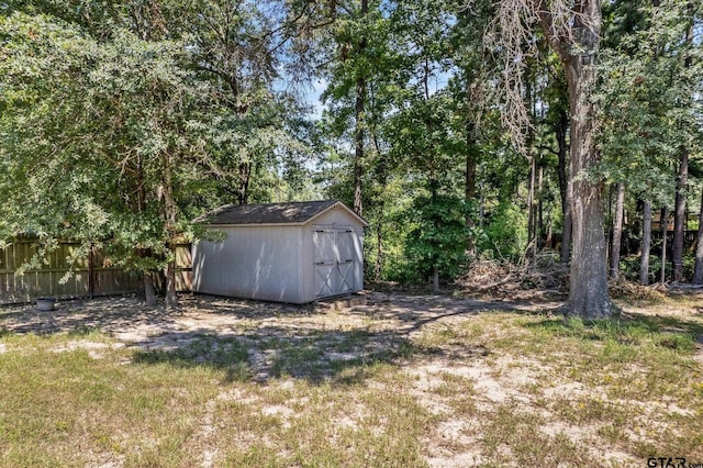 view of shed with fence