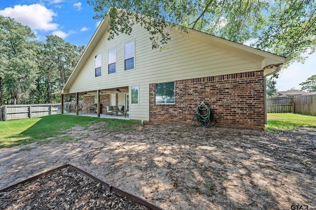 rear view of property featuring a patio area, brick siding, ceiling fan, and a fenced backyard