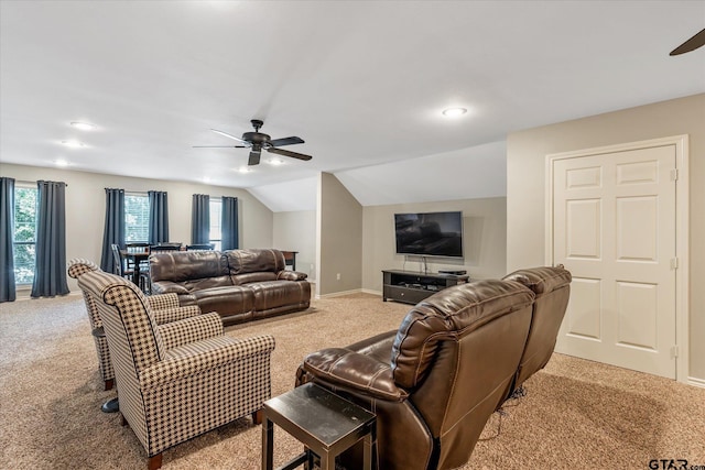 living room featuring lofted ceiling, light carpet, ceiling fan, and baseboards