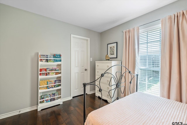 bedroom with dark wood-style flooring and baseboards