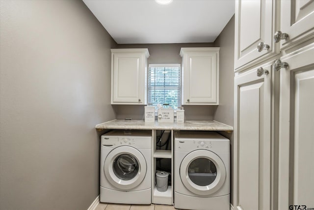 laundry room with cabinet space, light tile patterned floors, baseboards, and separate washer and dryer