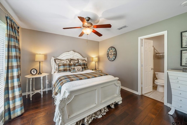 bedroom featuring hardwood / wood-style flooring, ensuite bath, visible vents, and baseboards