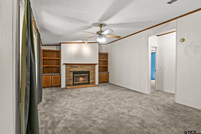 364 San Saba Ln, Mount Vernon, TX 75457 - unfurnished living room featuring ornamental molding, ceiling fan, carpet, a fireplace, and a textured ceiling