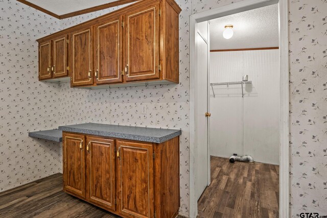364 San Saba Ln, Mount Vernon, TX 75457 - washroom featuring crown molding, wallpapered walls, dark wood-style flooring, and a textured ceiling