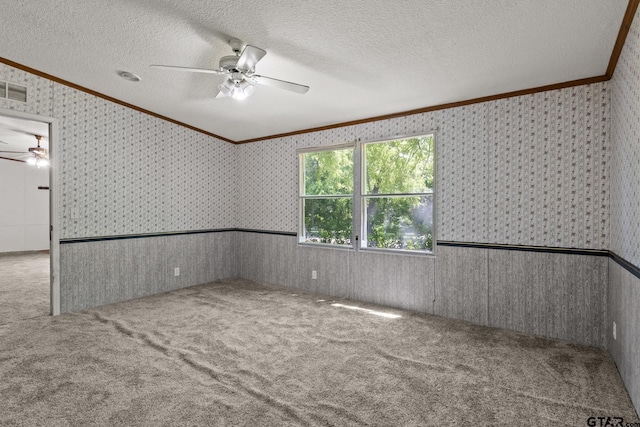 364 San Saba Ln, Mount Vernon, TX 75457 - carpeted empty room featuring a textured ceiling, wallpapered walls, ceiling fan, and ornamental molding