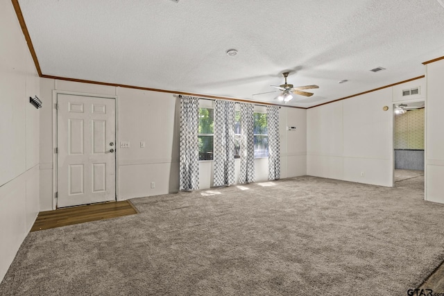 364 San Saba Ln, Mount Vernon, TX 75457 - unfurnished living room featuring ornamental molding, a ceiling fan, carpet flooring, and visible vents