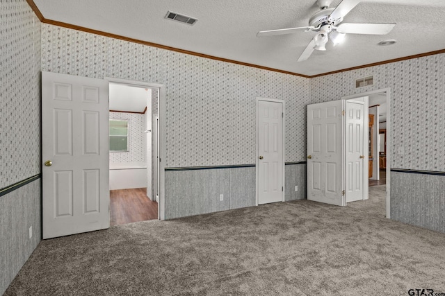 364 San Saba Ln, Mount Vernon, TX 75457 - unfurnished bedroom featuring carpet flooring, visible vents, and crown molding