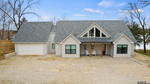 modern inspired farmhouse with a garage