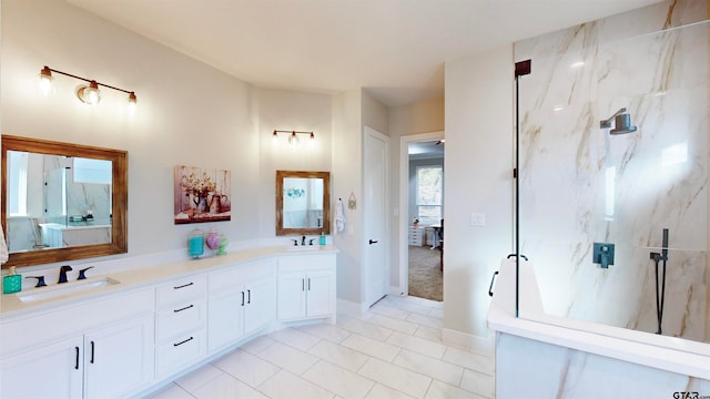 bathroom with a tile shower, vanity, and tile patterned floors