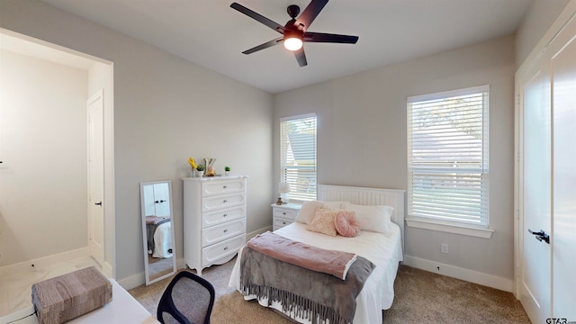 bedroom with multiple windows, light carpet, and ceiling fan