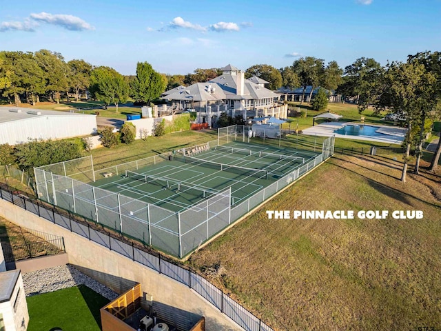 view of property's community featuring tennis court, a lawn, and a swimming pool