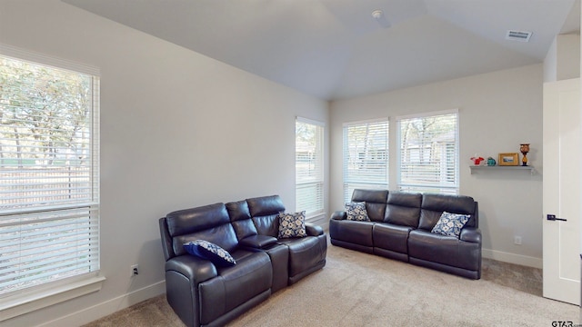 carpeted living room with lofted ceiling