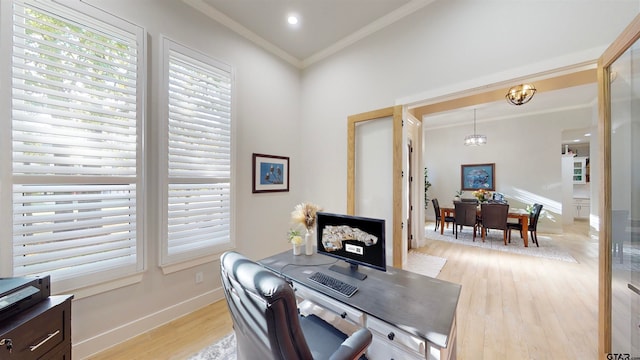 office space with ornamental molding, light hardwood / wood-style flooring, and a chandelier