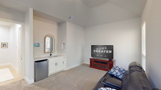 carpeted living room with wet bar