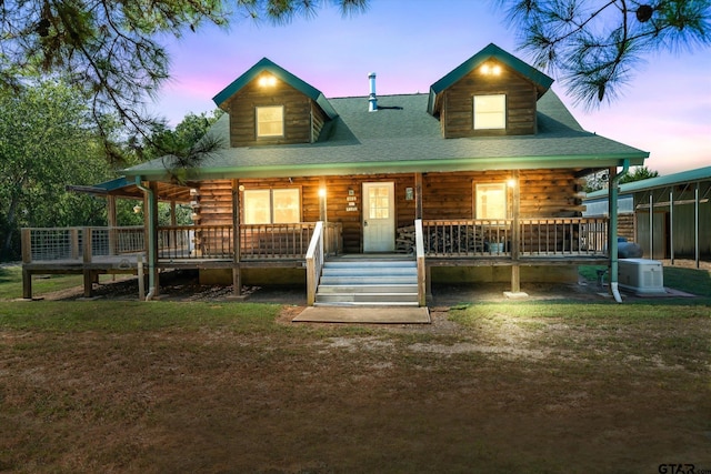 11698 Piper Ln, Frankston, TX 75763 - view of front of house with log siding, a porch, and a lawn