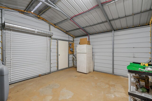 11698 Piper Ln, Frankston, TX 75763 - garage featuring metal wall and freestanding refrigerator