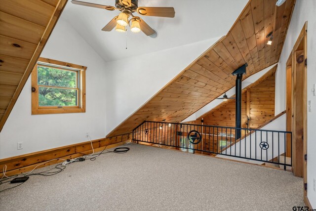 11698 Piper Ln, Frankston, TX 75763 - additional living space featuring lofted ceiling, ceiling fan, carpet floors, and wooden walls