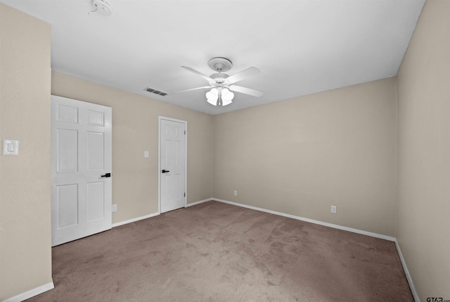 interior space featuring baseboards, ceiling fan, and visible vents