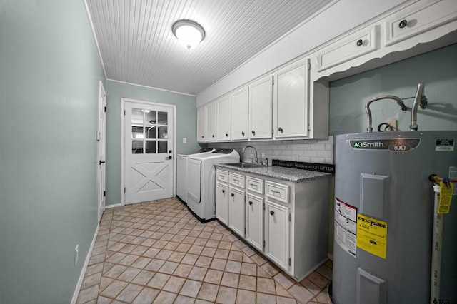 laundry area featuring baseboards, independent washer and dryer, a sink, cabinet space, and water heater