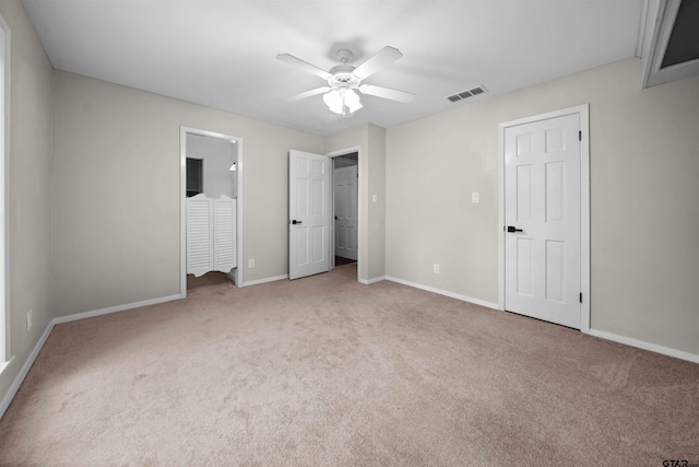 unfurnished bedroom with ceiling fan, visible vents, baseboards, ensuite bathroom, and carpet flooring