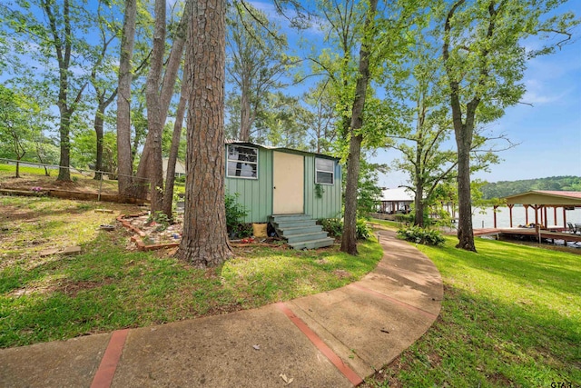 view of outbuilding with entry steps and fence
