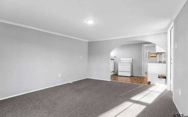 unfurnished living room with dark carpet, arched walkways, baseboards, and ornamental molding