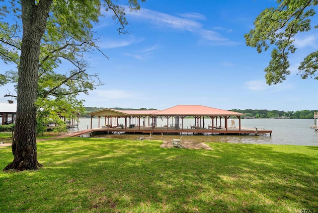 view of dock with a yard, a water view, and a gazebo