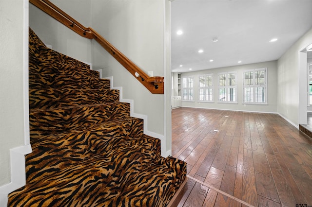 stairs featuring recessed lighting, baseboards, and hardwood / wood-style floors