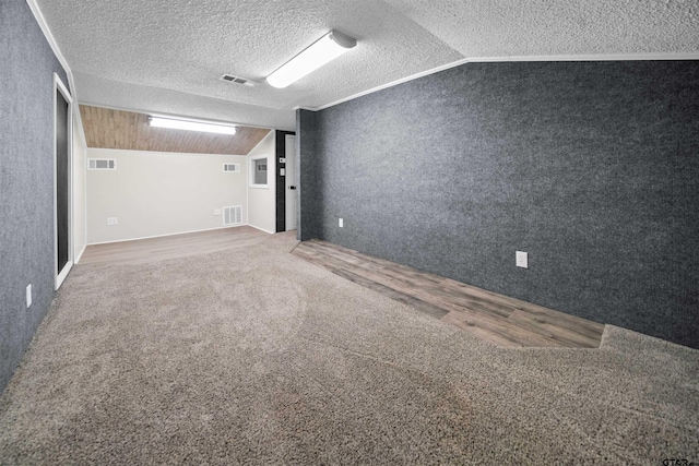 interior space featuring visible vents, carpet, and lofted ceiling