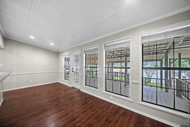 unfurnished room with french doors, crown molding, wood finished floors, baseboards, and recessed lighting