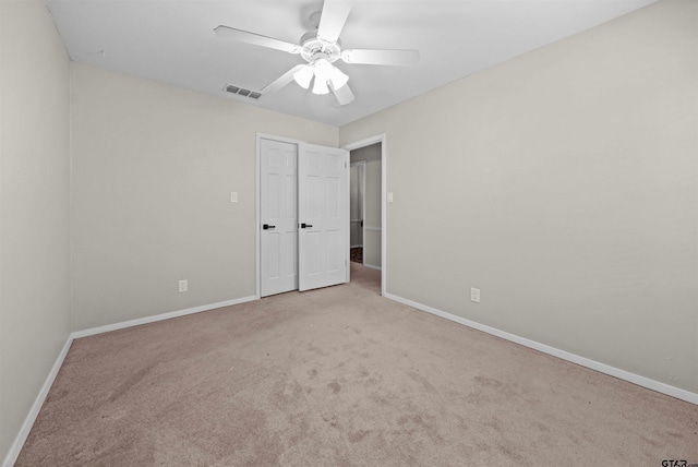 unfurnished bedroom with visible vents, carpet flooring, baseboards, and a ceiling fan