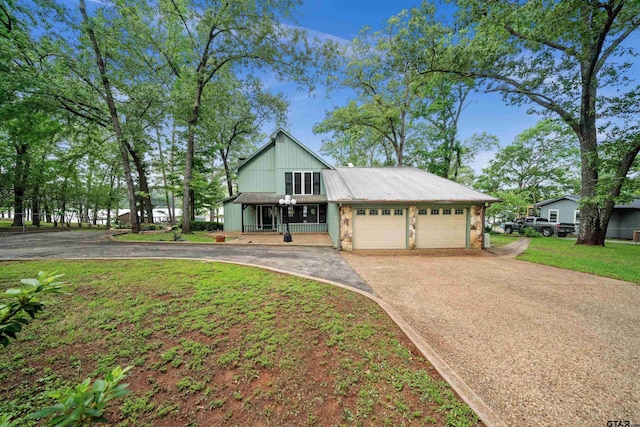 view of front of house featuring an attached garage, driveway, and a porch