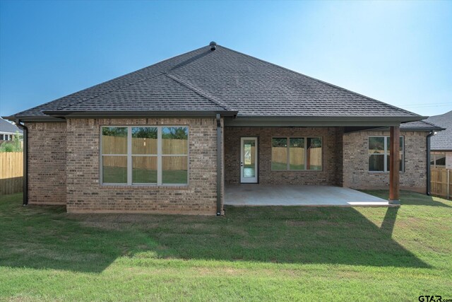 back of house featuring a patio and a yard