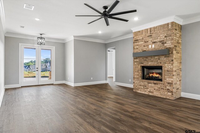 unfurnished living room with ornamental molding, a fireplace, and dark wood-type flooring