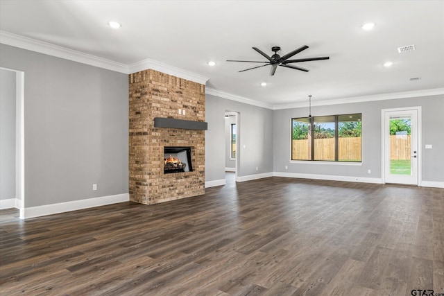 unfurnished living room featuring a fireplace, ceiling fan, dark hardwood / wood-style floors, and crown molding