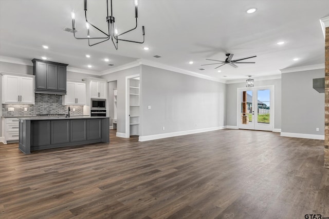 kitchen featuring gray cabinets, stainless steel appliances, dark hardwood / wood-style floors, and an island with sink