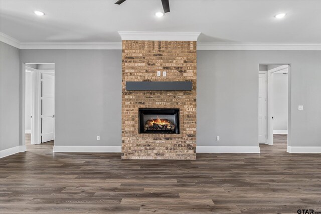 unfurnished living room with a fireplace, dark hardwood / wood-style floors, and ornamental molding